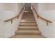 Indoor staircase with wooden handrail leading upstairs at 10325 W Windsor Ave, Avondale, AZ 85392