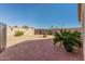 Landscaped backyard with brick patio and seating at 10334 W Sunbird Dr, Arizona City, AZ 85123