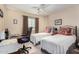 Bedroom with two twin beds, a desk and ceiling fan at 10334 W Sunbird Dr, Arizona City, AZ 85123