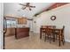 Kitchen with wood cabinets, an island, and a dining area at 10334 W Sunbird Dr, Arizona City, AZ 85123