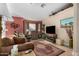 Living room with brown leather couches, a large TV, and a burgundy rug at 10334 W Sunbird Dr, Arizona City, AZ 85123