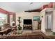 Living room with brown couches, a TV, and decorative plants at 10334 W Sunbird Dr, Arizona City, AZ 85123