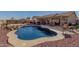 Relaxing kidney shaped pool with surrounding patio at 10334 W Sunbird Dr, Arizona City, AZ 85123