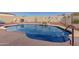 Refreshing kidney shaped pool with rock accents at 10334 W Sunbird Dr, Arizona City, AZ 85123