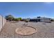 Spacious backyard with gravel and a stone bench at 10722 W Loma Blanca Dr, Sun City, AZ 85351