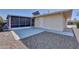 Backyard patio, screened enclosure, and gravel landscaping at 10722 W Loma Blanca Dr, Sun City, AZ 85351