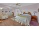 Bedroom with wood floors, mirrored closet, and ceiling fan at 10722 W Loma Blanca Dr, Sun City, AZ 85351