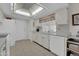 Well-equipped kitchen with ample counter space and white cabinets at 10722 W Loma Blanca Dr, Sun City, AZ 85351