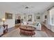 Living room with hardwood floors, a sofa, and a coffee table at 10722 W Loma Blanca Dr, Sun City, AZ 85351