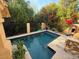 Rectangular pool with travertine decking and lush landscaping at 10846 N 11Th St, Phoenix, AZ 85020