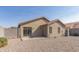 Backyard view of house with gravel and block wall at 11261 E Quarry Ave, Mesa, AZ 85212