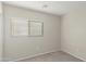 Simple bedroom with neutral walls and carpet flooring at 11261 E Quarry Ave, Mesa, AZ 85212