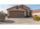 Tan house with a brown garage door and small front yard at 11261 E Quarry Ave, Mesa, AZ 85212