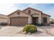 One-story house with brown garage door and landscaping at 11261 E Quarry Ave, Mesa, AZ 85212