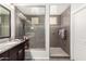 Modern bathroom with walk-in shower, granite vanity, and dark wood cabinets at 12064 S 186Th Ave, Goodyear, AZ 85338