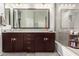 Double vanity bathroom with granite countertop and large mirror at 12064 S 186Th Ave, Goodyear, AZ 85338