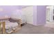 bedroom with crib, toddler bed, and purple walls at 12064 S 186Th Ave, Goodyear, AZ 85338