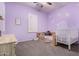 Pastel-colored bedroom with crib and desk area at 12064 S 186Th Ave, Goodyear, AZ 85338