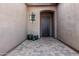 Front entry with decorative wrought-iron door and tile flooring at 12064 S 186Th Ave, Goodyear, AZ 85338