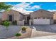 House exterior featuring a two-car garage and desert landscaping at 12064 S 186Th Ave, Goodyear, AZ 85338