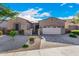 Single-story home with a two-car garage and landscaped front yard at 12064 S 186Th Ave, Goodyear, AZ 85338