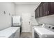 Bright laundry room with built-in cabinets and storage at 12064 S 186Th Ave, Goodyear, AZ 85338