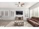 Spacious living room featuring a large sectional sofa and plenty of natural light at 12064 S 186Th Ave, Goodyear, AZ 85338