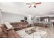 Open concept living room with a large sectional sofa and views into the kitchen at 12064 S 186Th Ave, Goodyear, AZ 85338