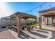 Backyard patio with covered seating area and fire pit at 12064 S 186Th Ave, Goodyear, AZ 85338