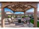 Backyard patio with covered seating area and fire pit at 12064 S 186Th Ave, Goodyear, AZ 85338