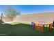 Fenced backyard featuring artificial turf and a colorful playpen, providing a safe play area at 1255 N Arizona Ave # 1255, Chandler, AZ 85225