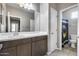 Bathroom featuring a double sink vanity, large mirror and separate toilet area at 1255 N Arizona Ave # 1255, Chandler, AZ 85225