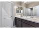 Bathroom featuring a double sink vanity with dark cabinets and a large mirror at 1255 N Arizona Ave # 1255, Chandler, AZ 85225