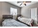 Neutral toned bedroom with two beds, rustic headboards, ceiling fan, and window at 1255 N Arizona Ave # 1255, Chandler, AZ 85225