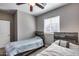 Neutral toned bedroom with two beds, rustic headboards, ceiling fan, and window at 1255 N Arizona Ave # 1255, Chandler, AZ 85225