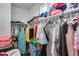 Walk-in closet featuring two rows of clothes and storage shelves at 1255 N Arizona Ave # 1255, Chandler, AZ 85225