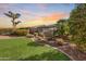 Landscaped backyard with artificial turf and trees at sunset at 12629 W Bajada Rd, Peoria, AZ 85383