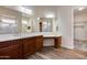 Bathroom with double vanity, large mirror, and walk-in closet at 12629 W Bajada Rd, Peoria, AZ 85383