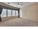 Bedroom with three windows, carpet flooring and ceiling fan at 12629 W Bajada Rd, Peoria, AZ 85383