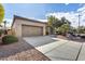 Tan stucco home with a two-car garage and desert landscaping at 12629 W Bajada Rd, Peoria, AZ 85383