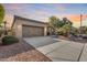 Two-car garage with a tan exterior and landscaping at 12629 W Bajada Rd, Peoria, AZ 85383