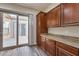 Laundry area with wood cabinets and access to backyard at 12629 W Bajada Rd, Peoria, AZ 85383