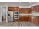 Spacious kitchen with wood cabinets, granite counters, and stainless steel appliances at 12629 W Bajada Rd, Peoria, AZ 85383