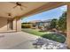 Covered patio and view of the grassy backyard at 12629 W Bajada Rd, Peoria, AZ 85383