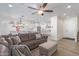 Open living room features a brown leather sectional sofa and a view into the kitchen at 1349 N Balboa --, Mesa, AZ 85205