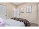 Well-lit bedroom with full-size bed and access to hallway bathroom at 14836 W Desert Hills Dr, Surprise, AZ 85379