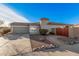 Single-story home with desert landscaping and a gated courtyard entry at 14836 W Desert Hills Dr, Surprise, AZ 85379