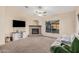 Living room featuring a stone fireplace and a comfy gray sofa at 14836 W Desert Hills Dr, Surprise, AZ 85379