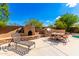 Outdoor kitchen area with a fireplace and seating for dining at 16205 S 7Th St, Phoenix, AZ 85048