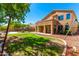 Landscaped backyard with a covered patio and swing set at 16205 S 7Th St, Phoenix, AZ 85048